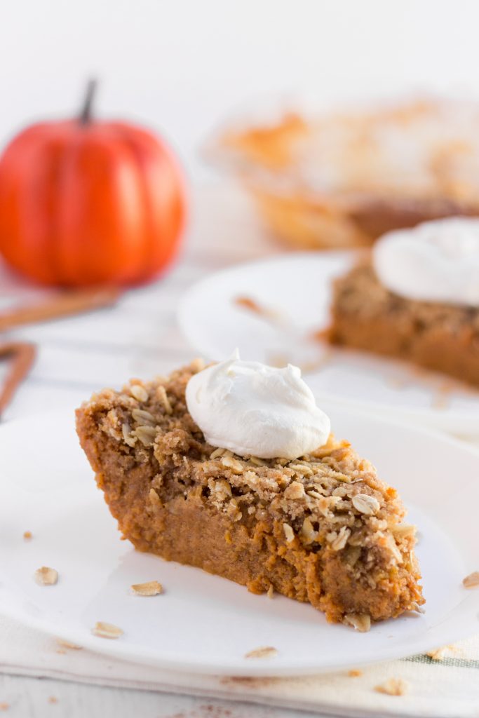 slice of Pumpkin Crisp Pie on a plate, topped with whipped cream