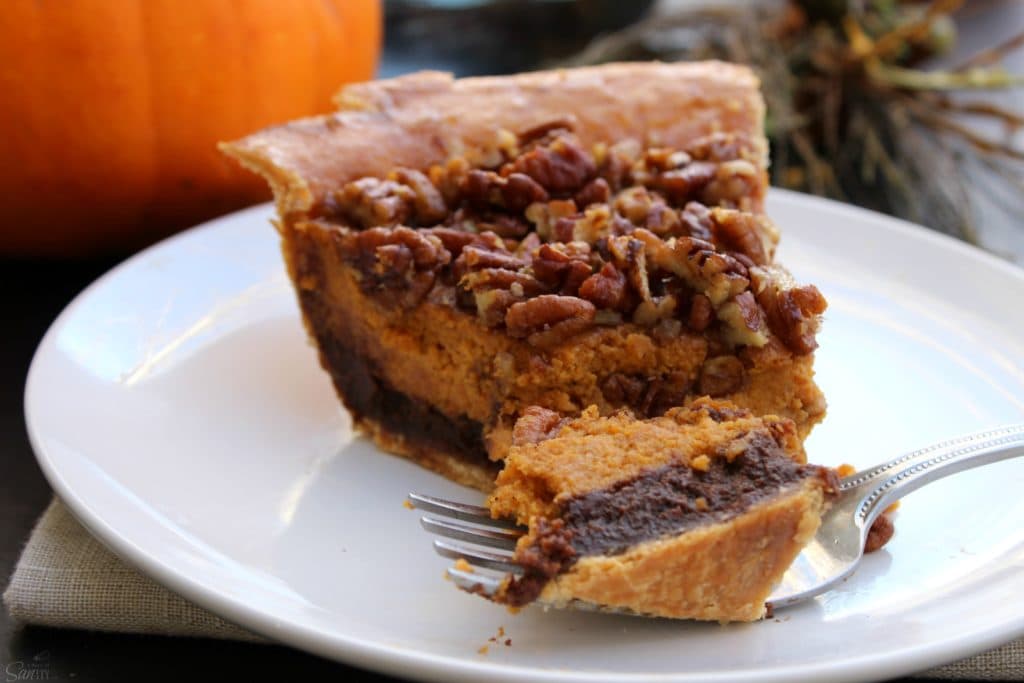 Chocolate Pecan Pumpkin Pie rich chocolate "brownie like" bottom, classic pumpkin pie and topped with pecans all baked into one delicious pie.