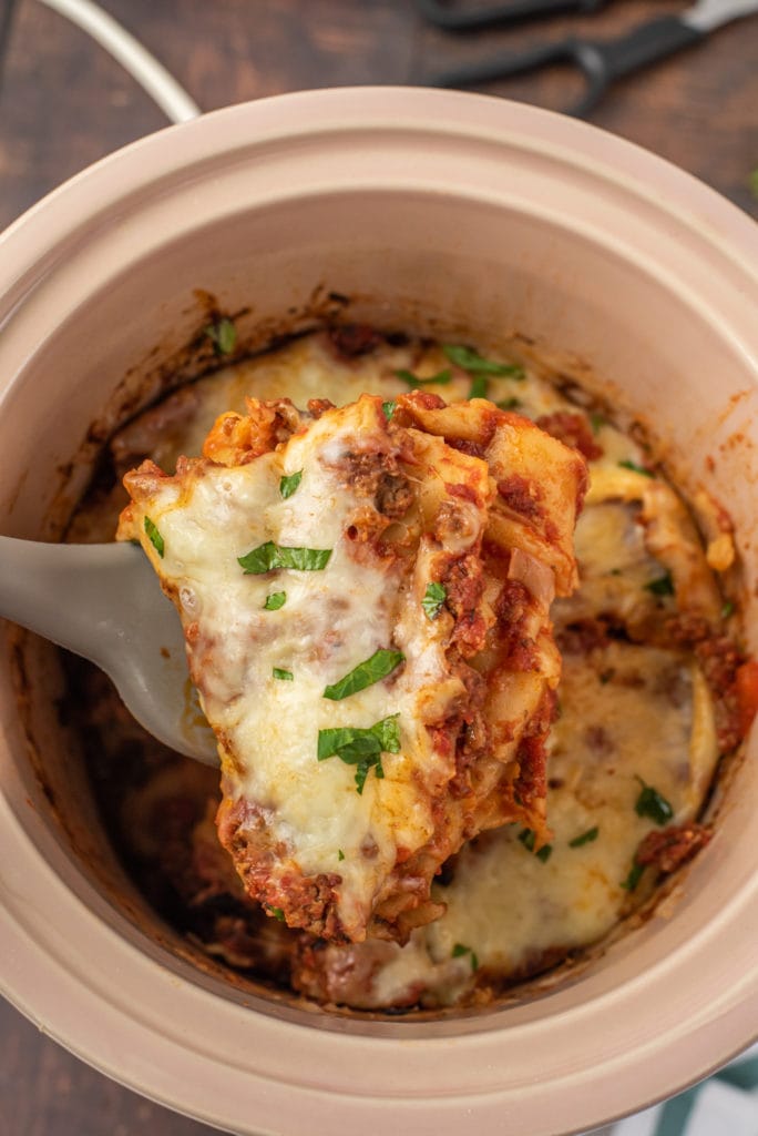 photo of a slice of lasagna being lifted out of the slow cooker