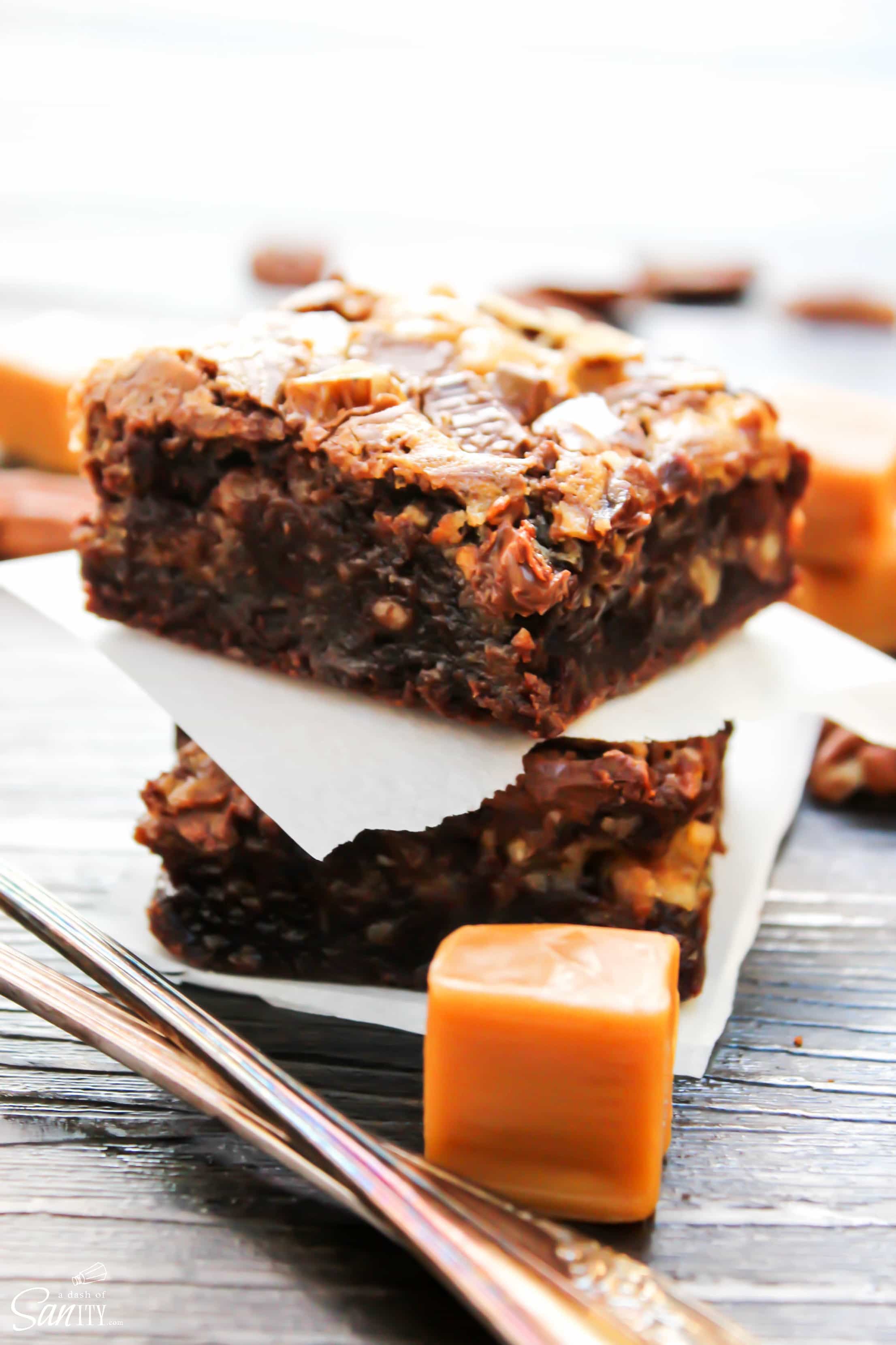 Turtle Cheesecake Fudge Brownies are rich fudge brownies with a caramel cheesecake swirl, topped with chopped pecans. #Spreadcheer with this decadent treat.