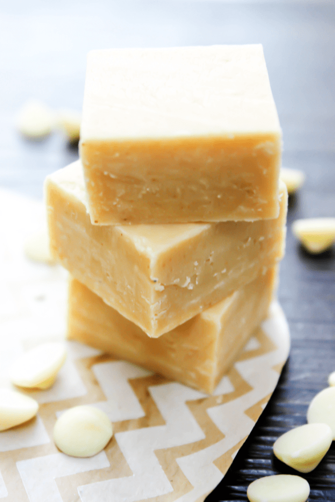 A stack of three pieces of white chocolate fudge.