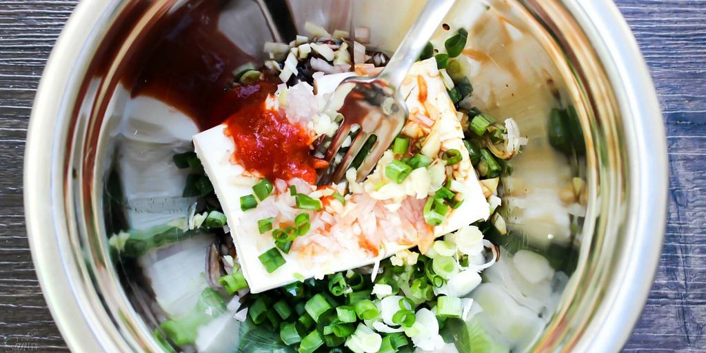 Baked Chicken Wontons are a healthier version of the classic cream-cheese wonton, with a chicken filling flavored with sesame, green onions and sriracha.