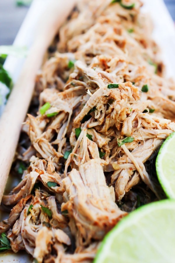 Slow Cooker Chili Lime Pulled Pork is made with a chili rub, fresh cilantro, and cooked in lime juice. This is the easiest, juiciest pulled pork recipe.