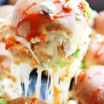 shot of buffalo chicken slider being pulled from pan