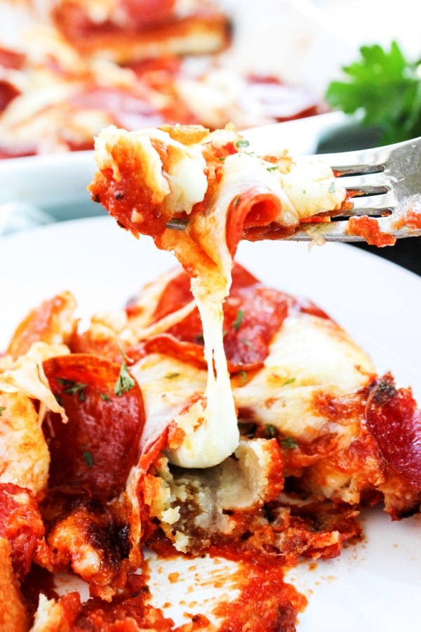 photo of the grilled cheese stick casserole on a plate with a bite on a fork