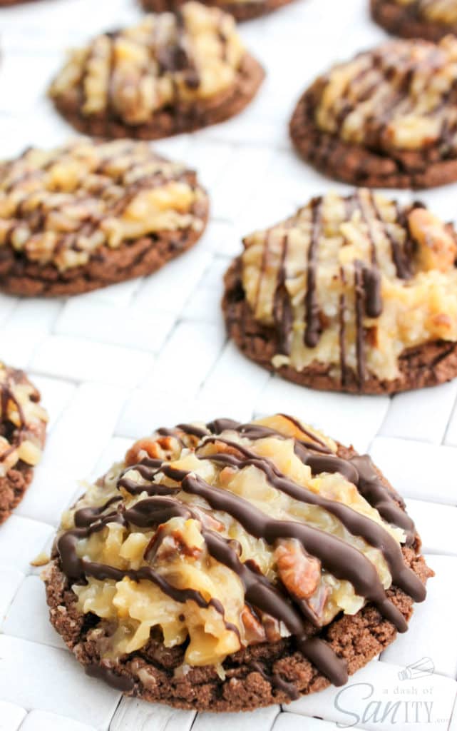 close up photo of German Chocolate Cake Cookies with coconut pecan frosting and chocolate drizzle laid out on counter