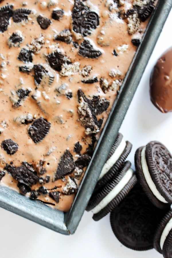 overhead photo of nutella ice cream in a metal pan next to full oreos