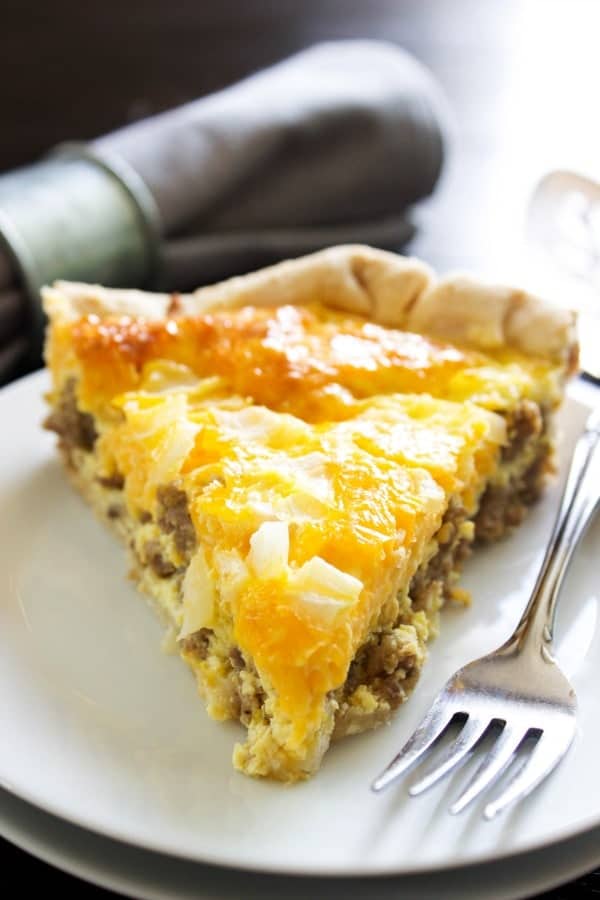 photo of slice of easy sausage quiche on white plate with fork