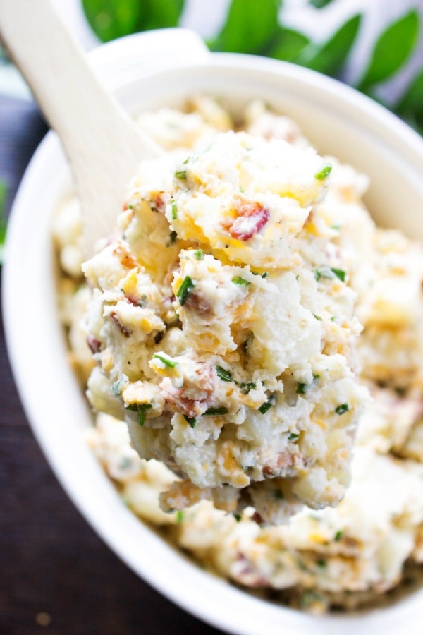 BEST EVER POTATO SALAD RECIPE, bacon, chives, cheddar cheese in white bowl with wooden spoon