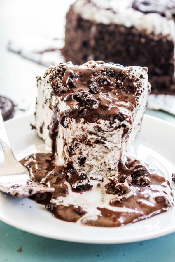 COOKIES & CREAM HOT FUDGE SAUCE - White plate, melted cake, metal spoon, blue table 