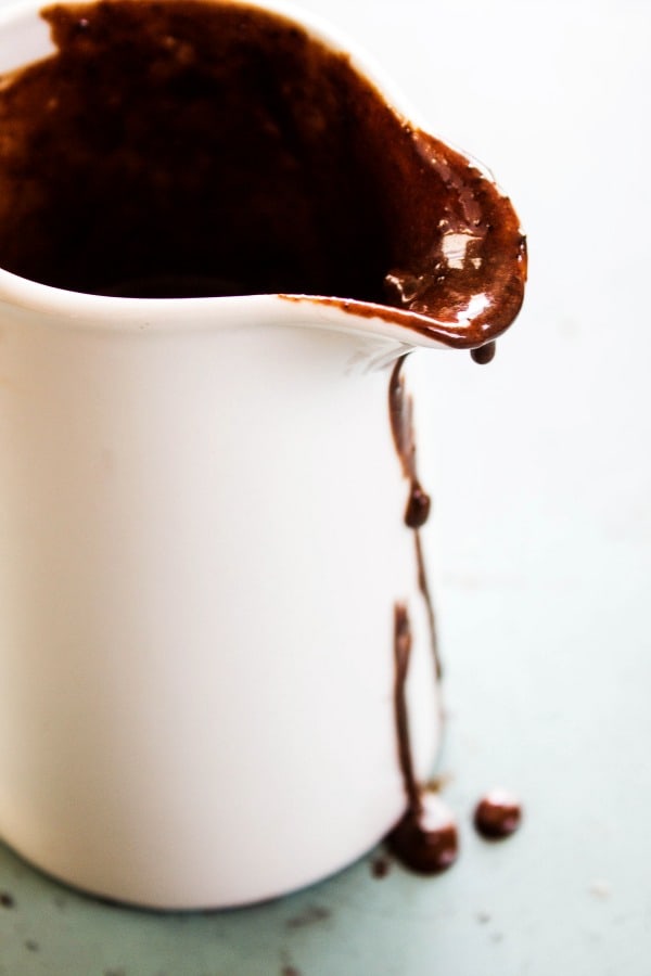 COOKIES & CREAM HOT FUDGE SAUCE - Chocolate sauce in porcelain saucer 