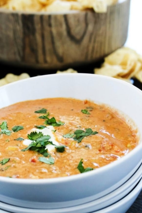 chicken chili dip in white bowl with chips