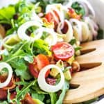 arugula salad in white bowl