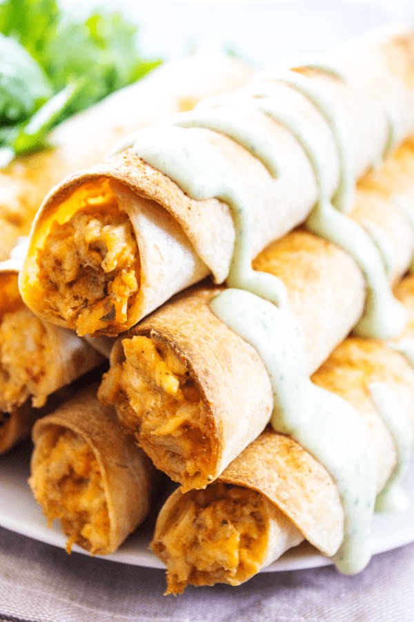 BAKED TACO RANCH TAQUITOS in a pyramid stack on a plate