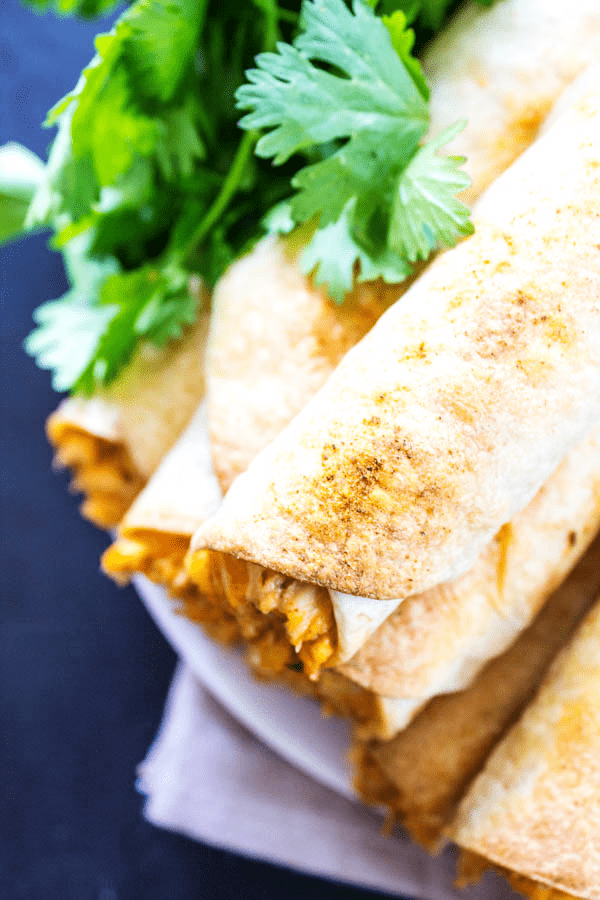 BAKED TACO RANCH TAQUITOS - Filled with a cheesy taco ranch chicken and then baked to perfection, they are perfect for any game day or holiday get together.