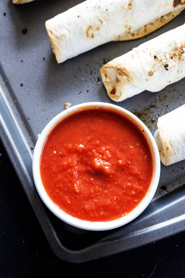 Chicken Parmesan Taquitos - Filled with chicken, cheeses & Italian seasoning, dunk in a marinara sauce & you have a simpler twist on an Italian classic.