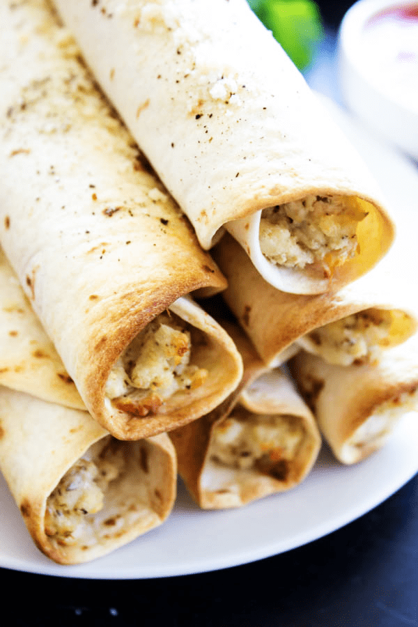 Chicken Parmesan Taquitos - Filled with chicken, cheeses & Italian seasoning, dunk in a marinara sauce & you have a simpler twist on an Italian classic.