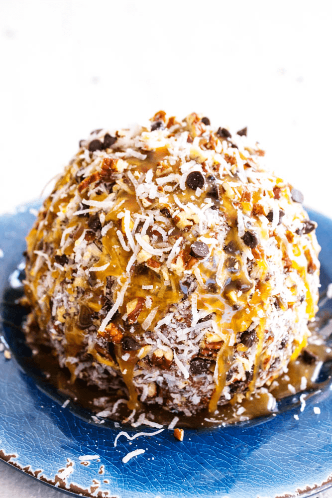 German Chocolate Cheesecake Ball prepared on a plate.