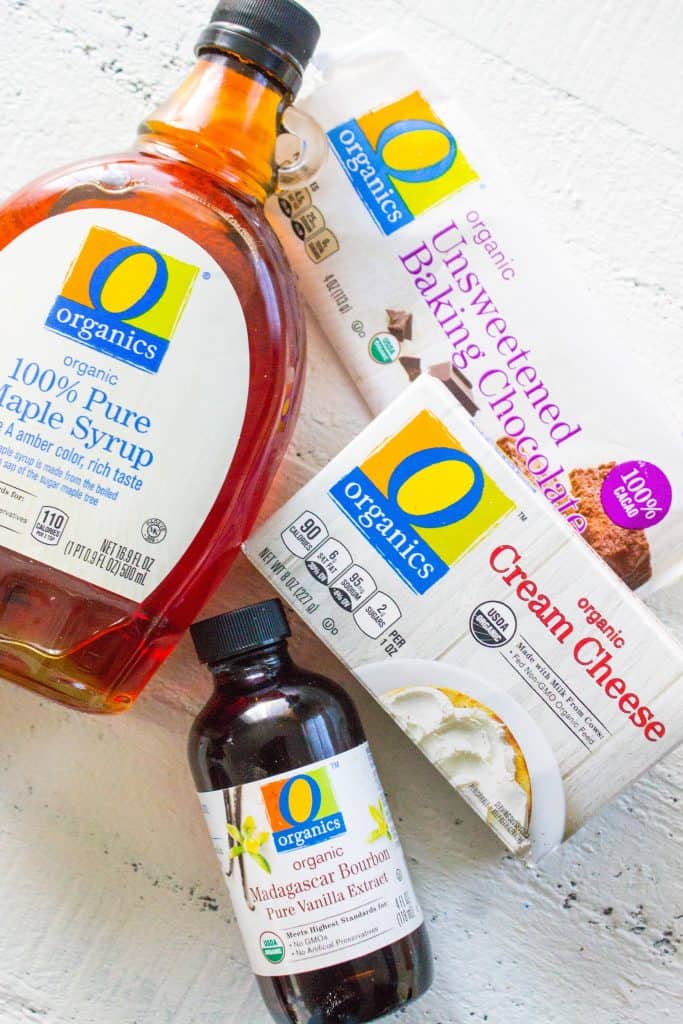 O Organics Products on counter: bottle of pure maple syrup, organic vanilla extract, box of cream cheese, unsweetened baking chocolate bare