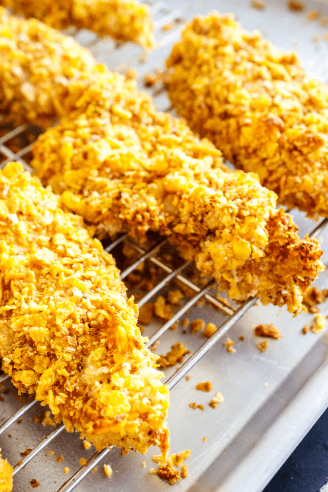 baked chicken tenders on a wire cooling rack over a sheet pan