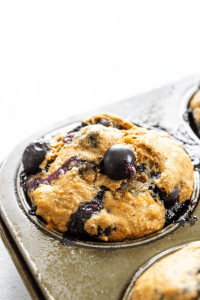 Simple and easy we love these {HEALTHIER} BANANA BLUEBERRY MUFFINS. Made with whole grains, flax seed and blueberries, they make a great breakfast or snack.