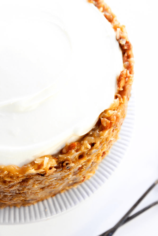 German Chocolate Carrot Cake frosted on a cake stand