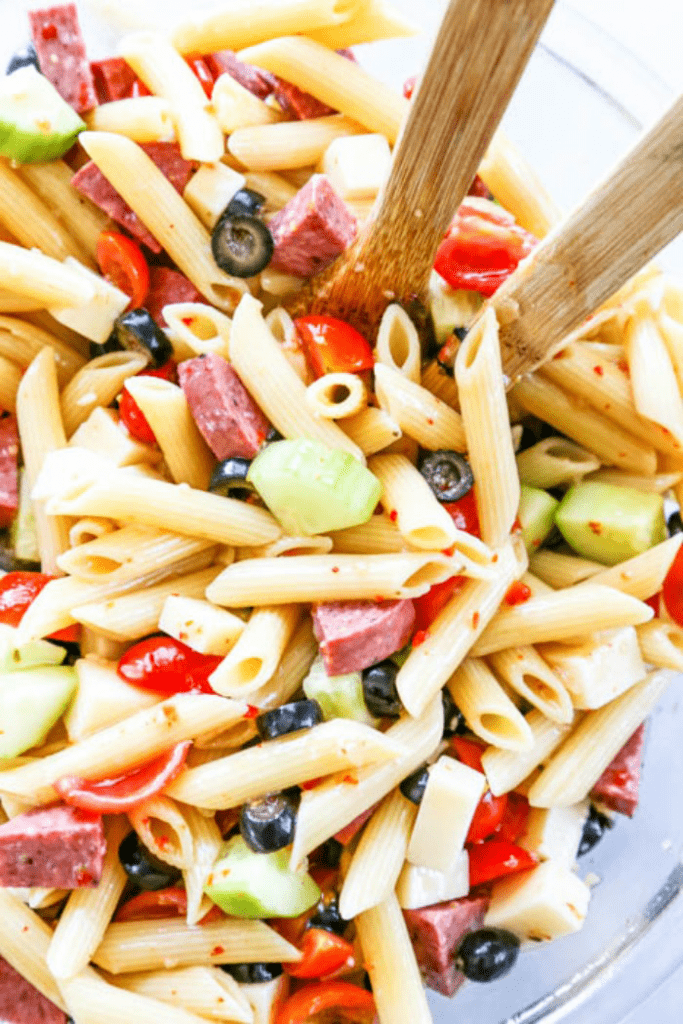 Easy Pasta Salad with Italian dressing, penne pasta, tomatoes, cucumbers, cheese, olives and salami