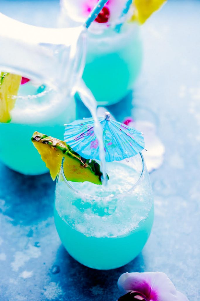 Refreshing & easy this Blue Island Cocktail/Mocktail is made with pineapple juice, limeade, pina colada mixer and lime juice, you can add rum for the adults.