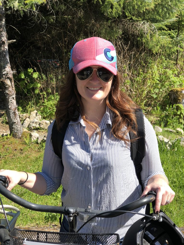 sandra standing on trail with a bike