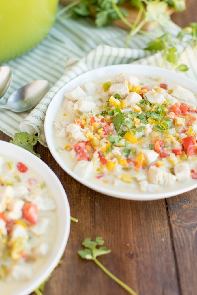 corn chowder in bowl with cilantro on the side