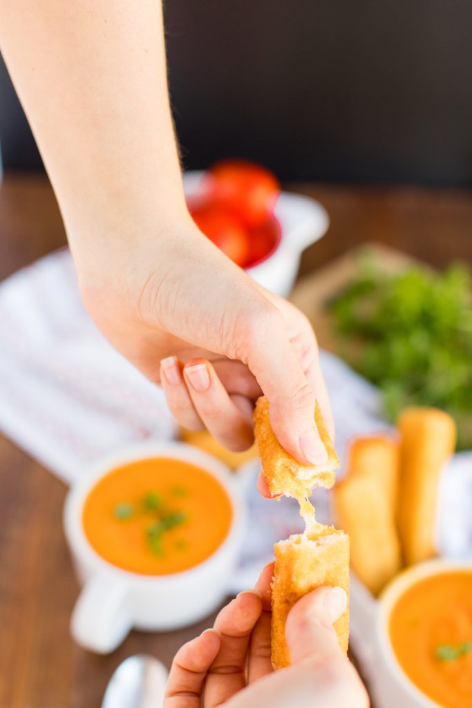 photo of someone pulling apart a grilled cheese stick 