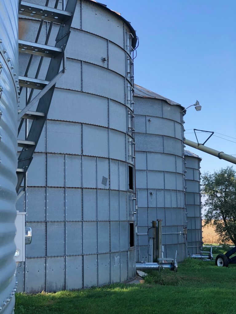 photo of a row of 4 corn silos