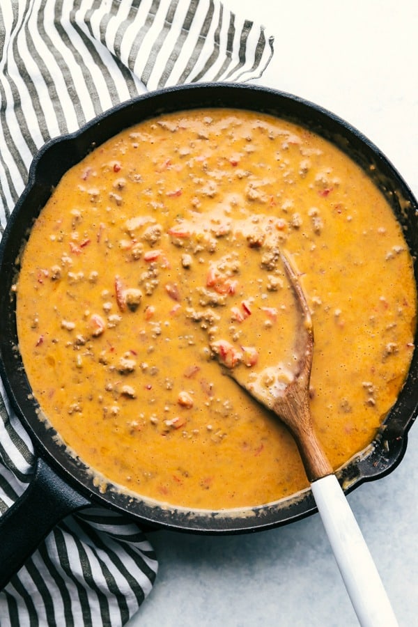 photo of Beef Queso in skillet with wooden spoon