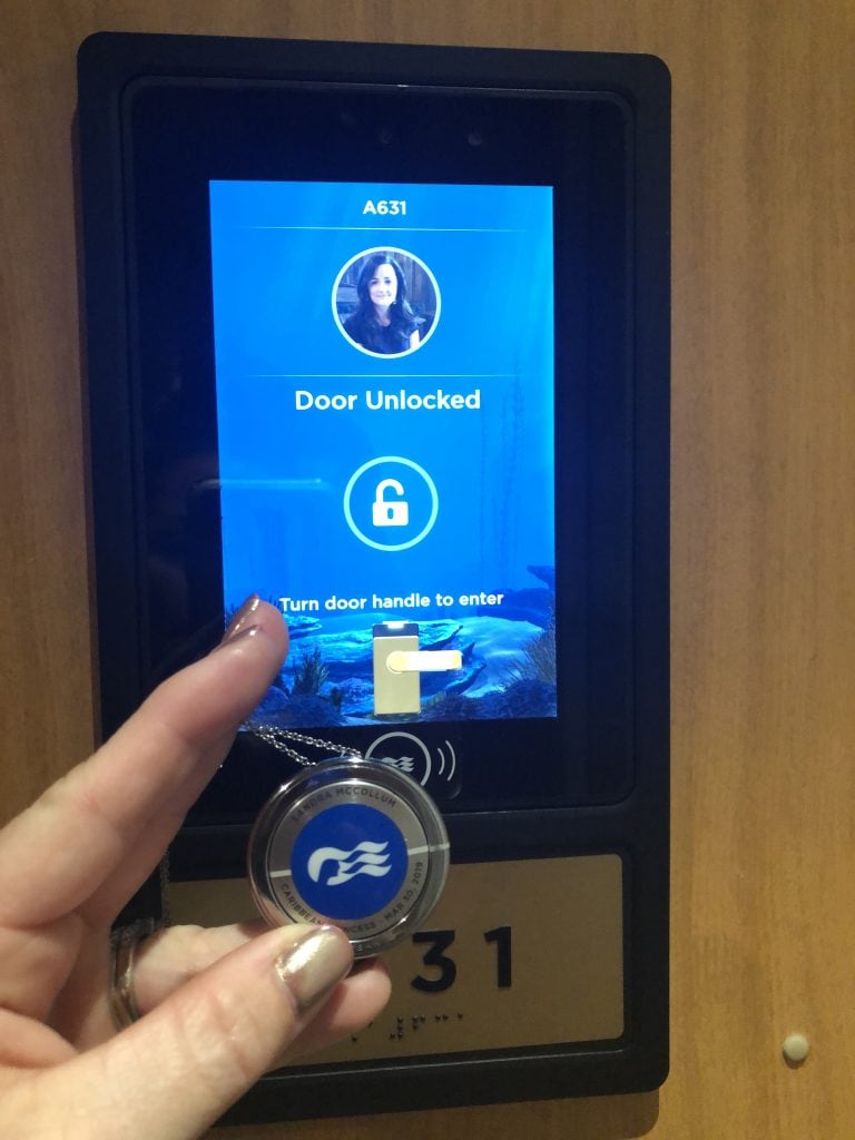 photo showing how ocean medallion can unlock doors on ship by holding up to a sensor