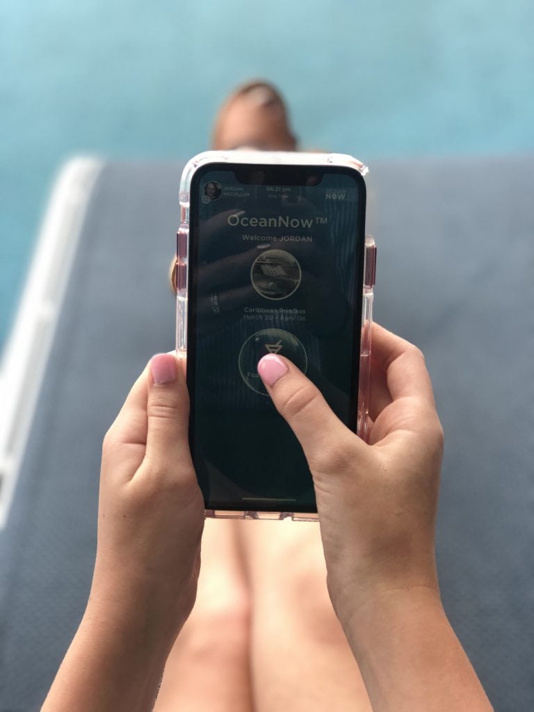 photo of ocean now app open on an iphone screen, clicking button to send drinks
