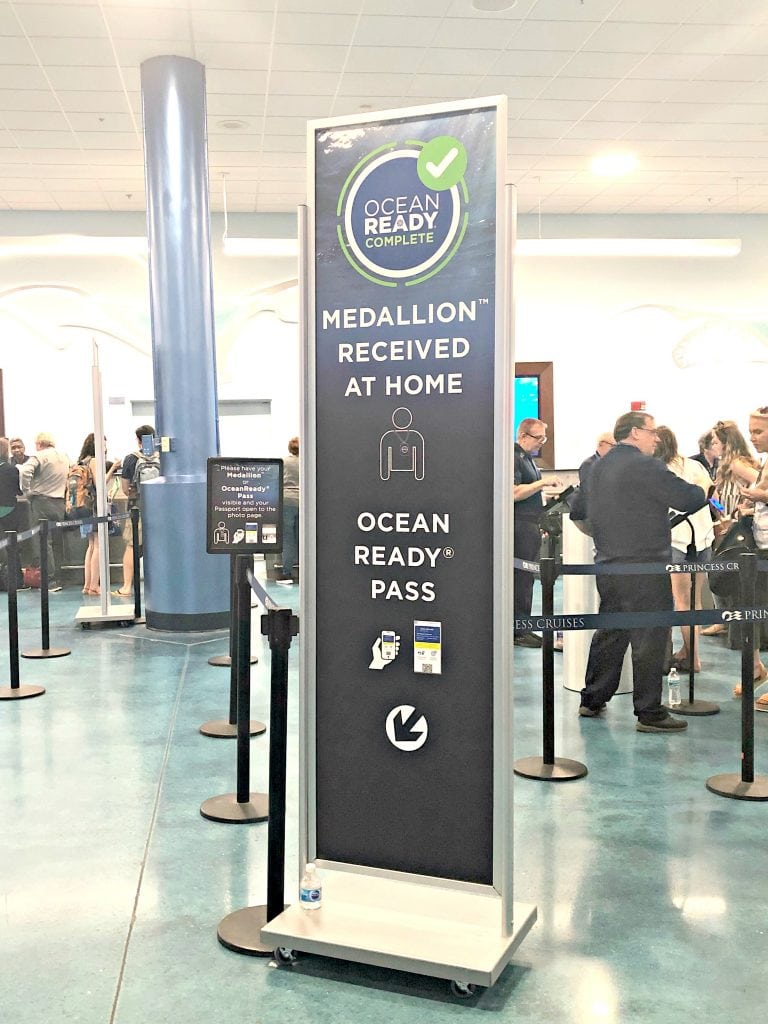 photo of a sign pointing to a queue. sign reads: Ocean Ready Complete. Medallion recieved at home. Ocean Ready pass