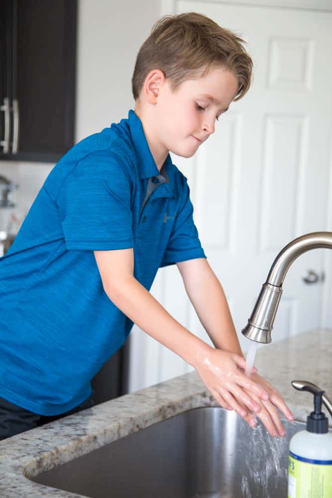 photo of a boy washing his hands