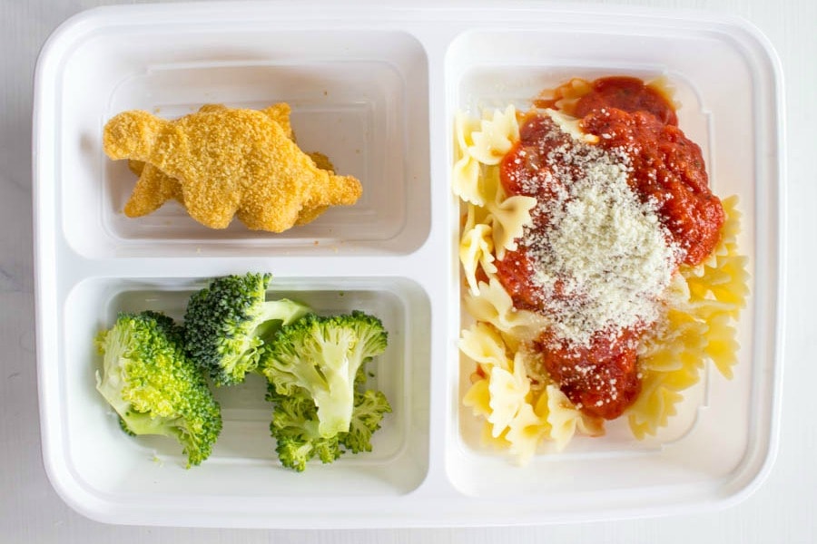 photo of lunch box with dino buddies nuggets, broccoli, and bowtie pasta with sauce and cheese