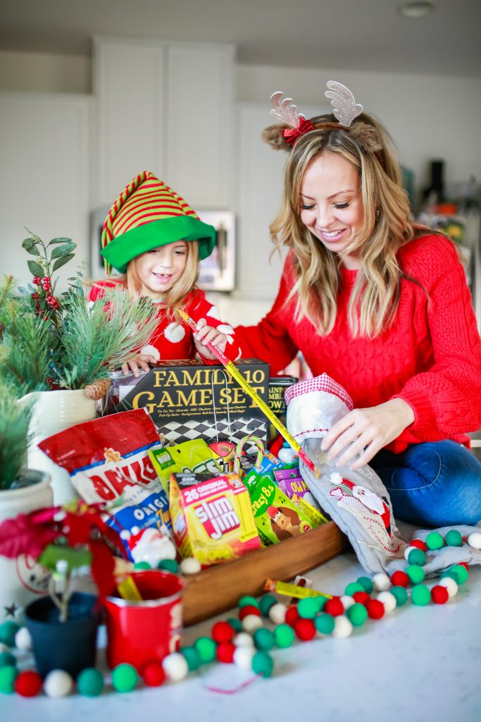 photo of mom and daugher taking slim jim out of the stocking in the Game Night Gift Basket