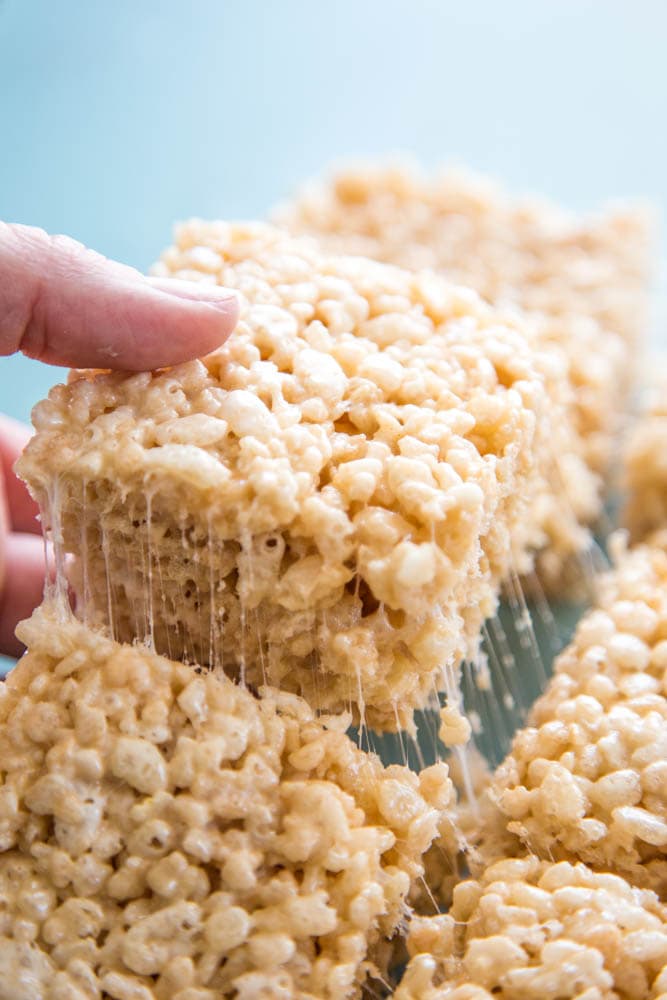 photo of a rice krispie treat being lifted out of the pan