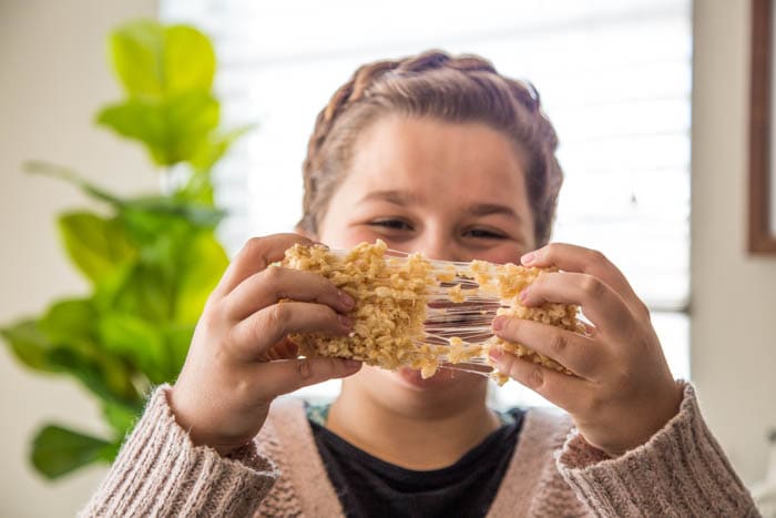 photo of a girl holding a rice krispie treat