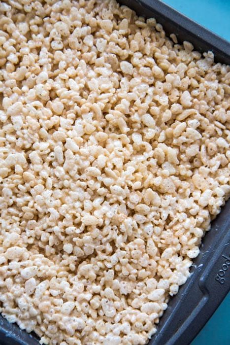 photo of the rice krispie mixture in a metal pan