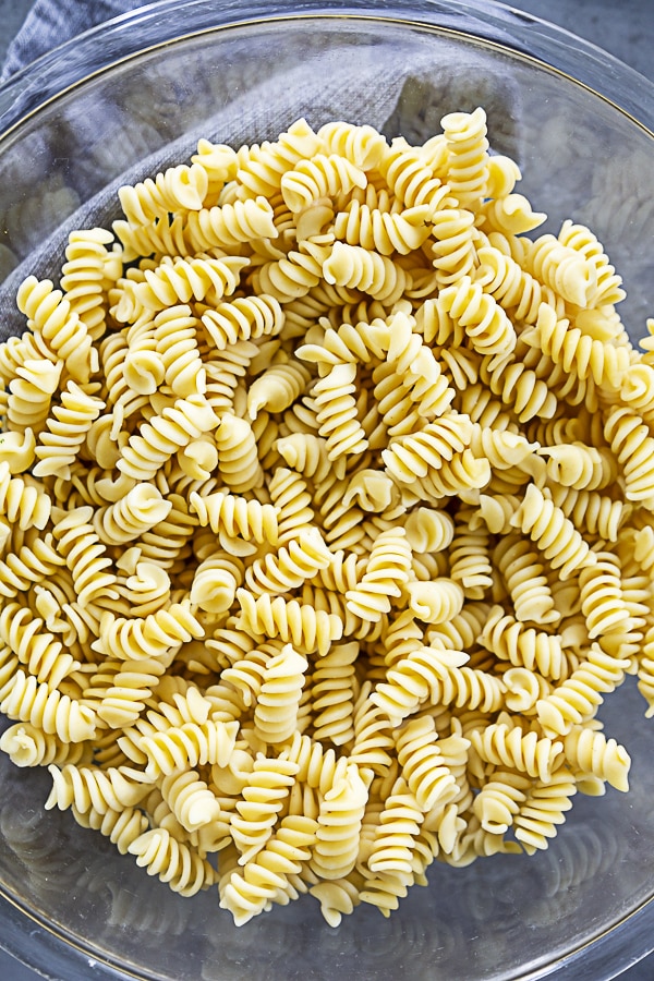 cooked pasta in mixing bowl