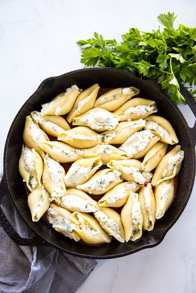 photo of all of the stuffed shells in the skillet.