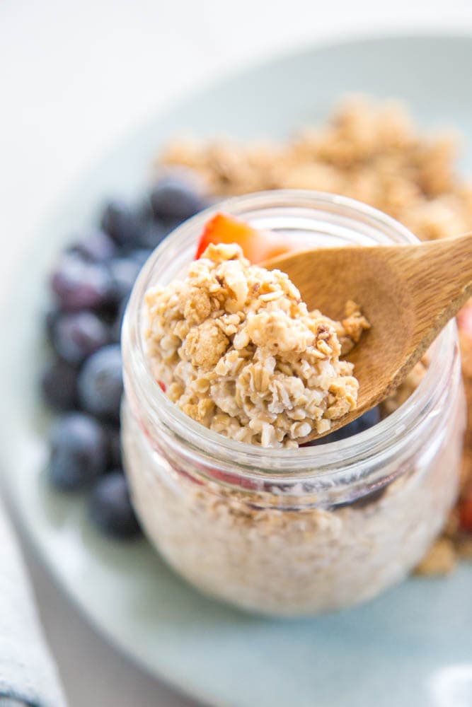 a spoon scooping some of the oats out of the jar