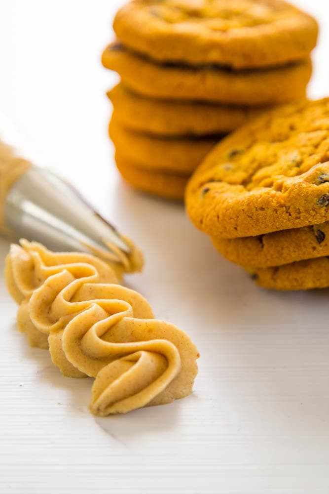 photo of piped frosting next to cookies.