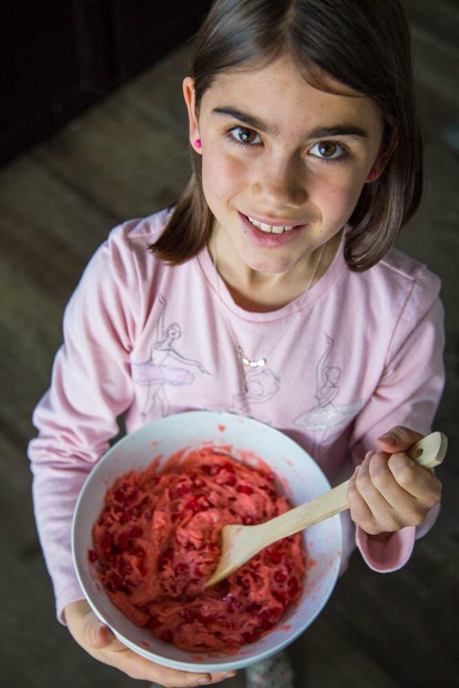 a girl mixing the cookie dough in a bowl