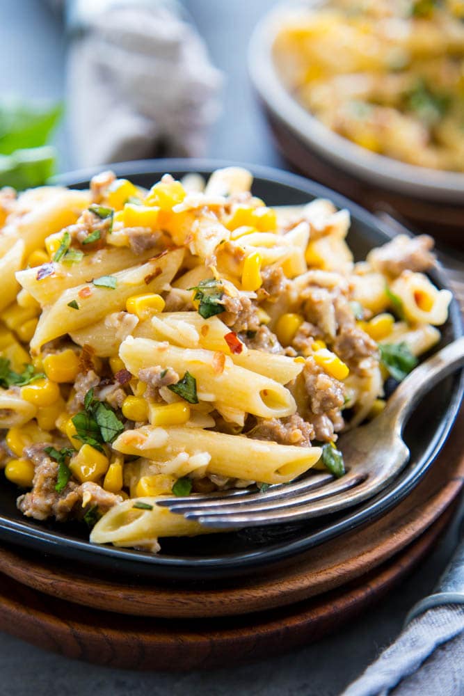 plate of pasta with corn and sausage