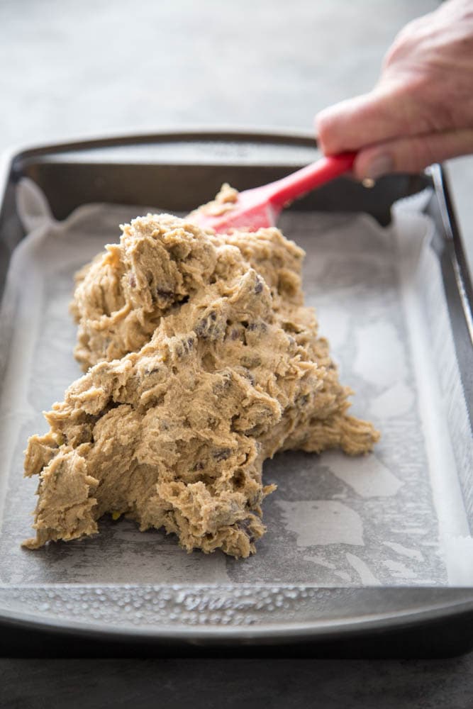 cookie dough being spread into a pan.