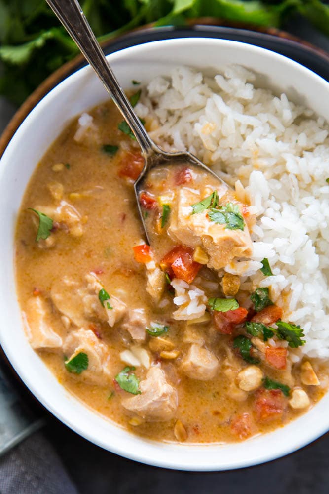 a bowl of curry chicken with rice.